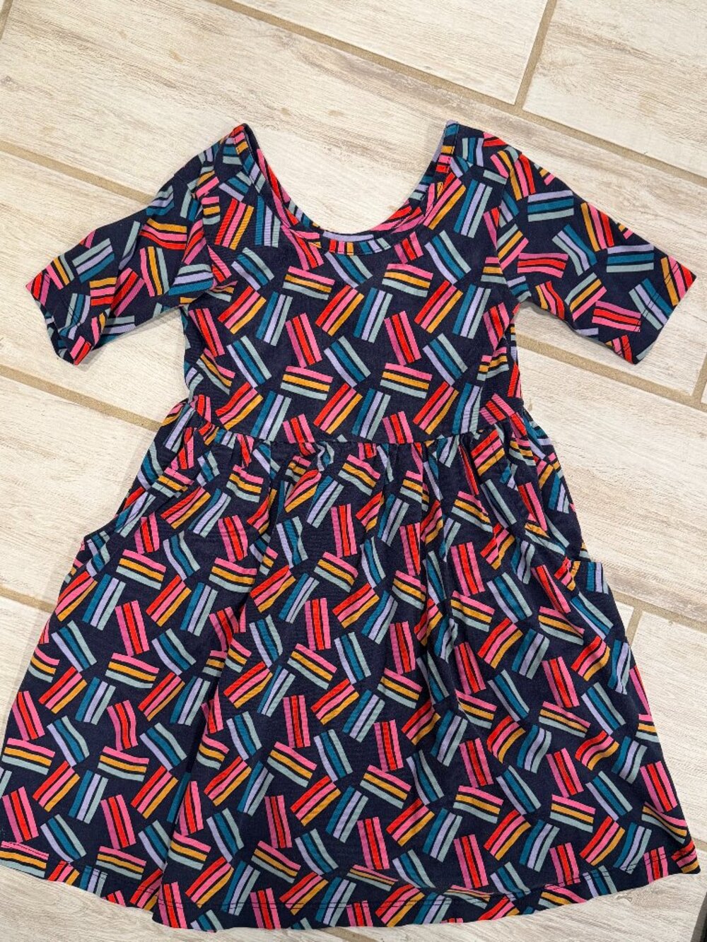 Hanna Andersson short-sleeve twirl dress in a cream base with colorful abstract